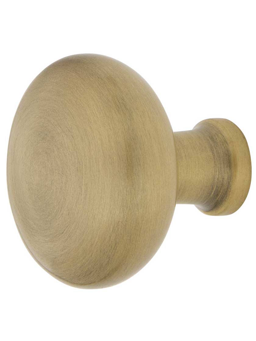 Classic Round Cabinet Knob - 1 3/8 inch Diameter in Antique Brass.